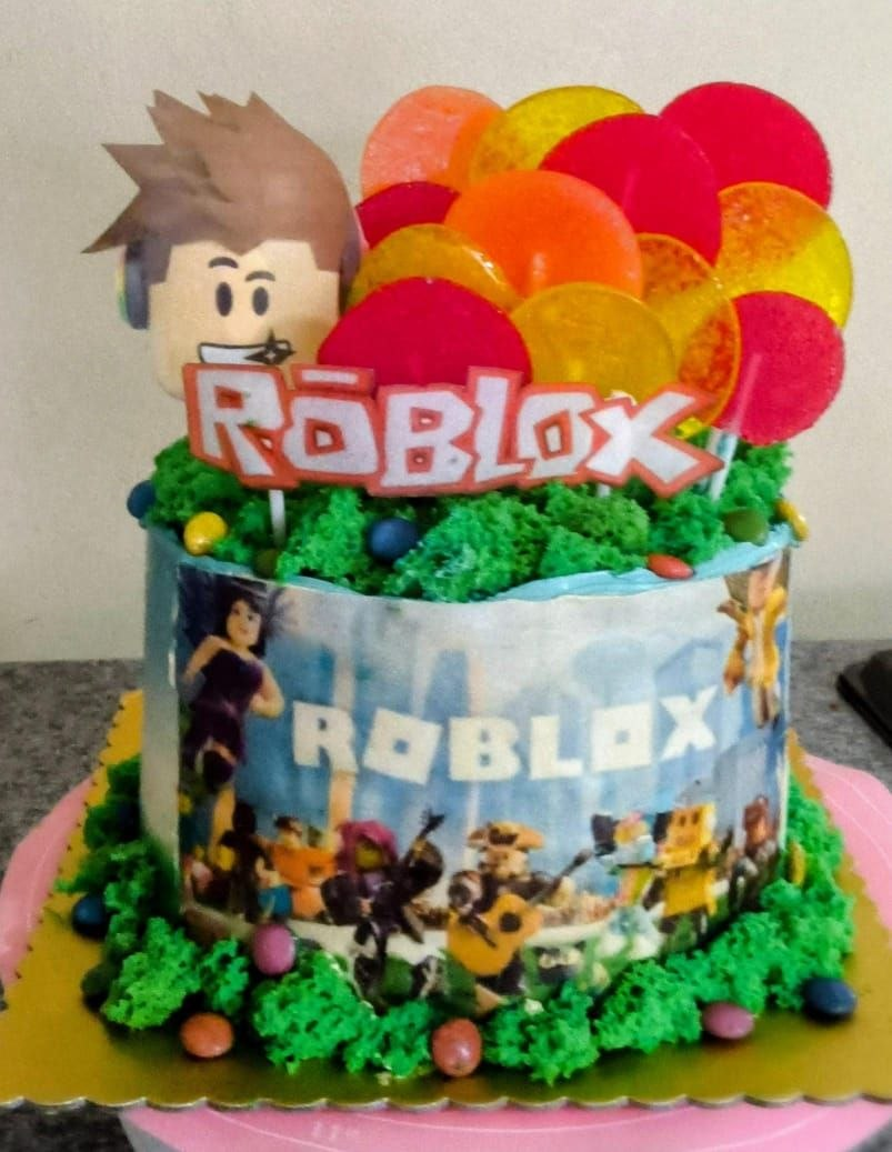 Red Roblox birthday cake with boy topper